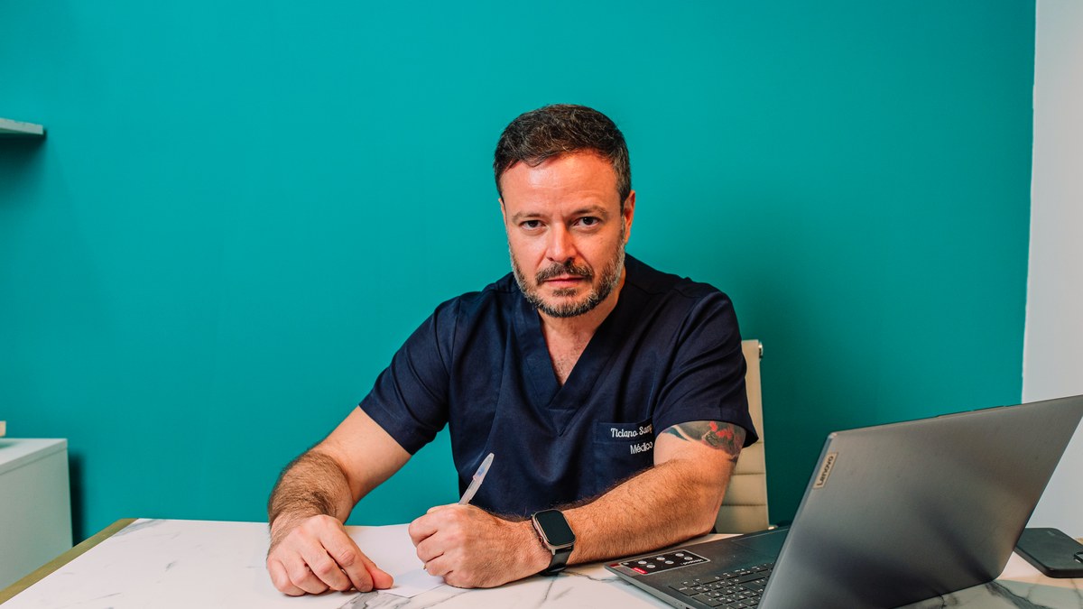 Dr. Ticiano Sampaio olhando para a câmera em seu consultório